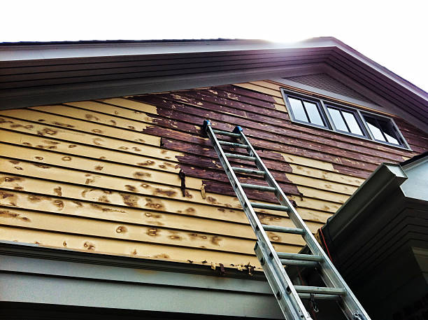 A house that is being stripped of old paint. chemical stripping