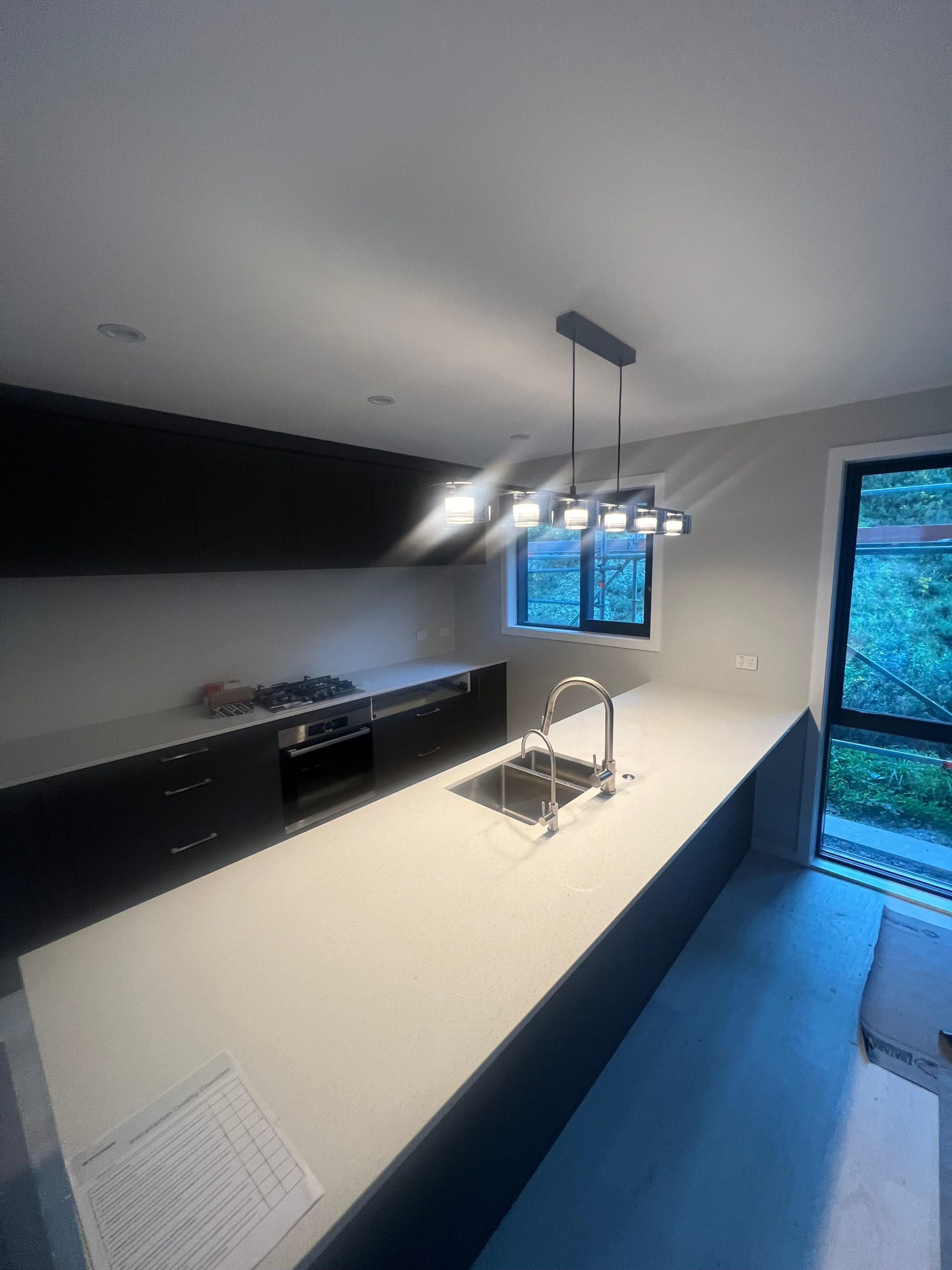 a kitchen with a sink and a window | House painting wellington